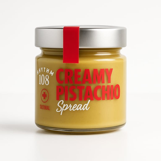 Jar of creamy pistachio spread with a red label on a white background