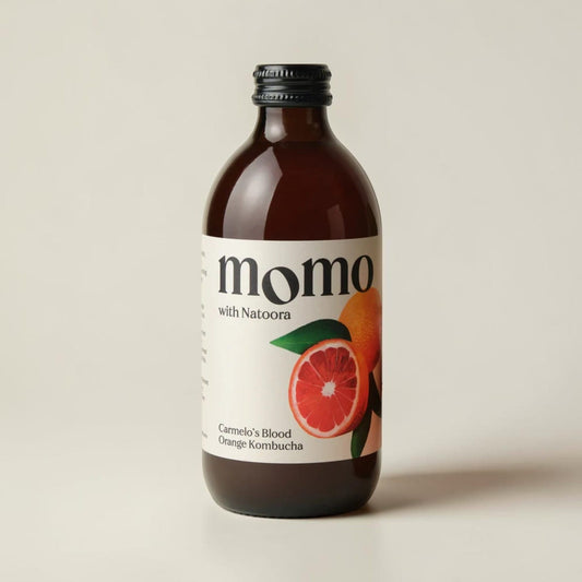 Momo Blood Orange Kombucha from Saporia | Artisan UK Vegan Cheesemonger & Deli, featuring a fresh Sicilian blood orange.